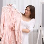Attractive woman with dress, choosing clothes