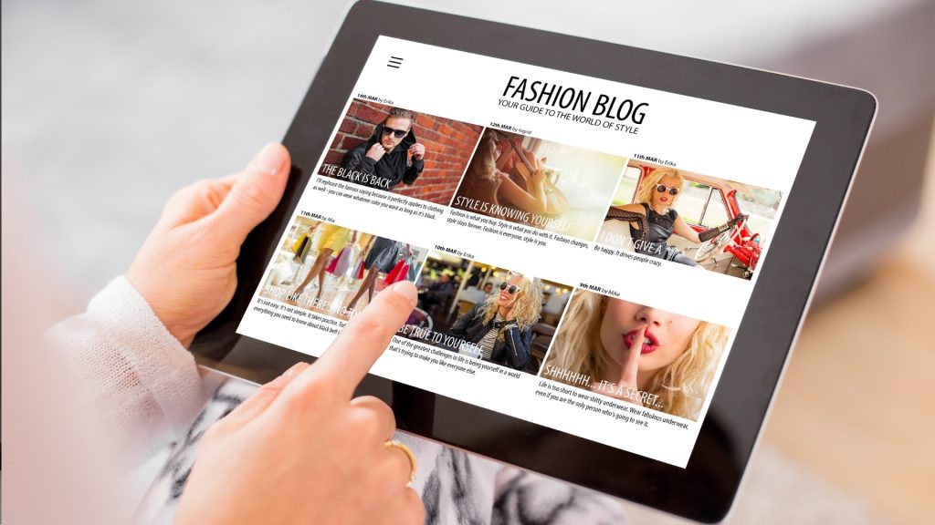 Woman reading fashion blog on tablet