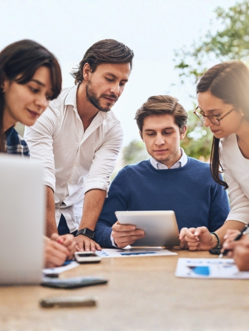 Group of young creative businesspeople working together outside